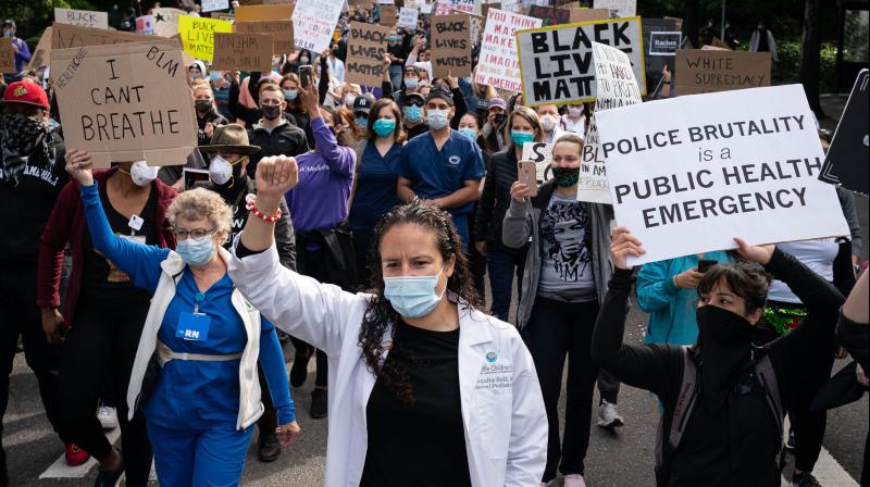 Healthcare workers and others march to Seattle City Hall during the Doctors For Justice event on June 6, 2020 in Seattle, Washington. (AFP)