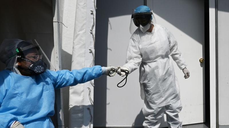 Health workers wearing protective gear are seen at the Central de Abastos market in Mexico City. (AFP)