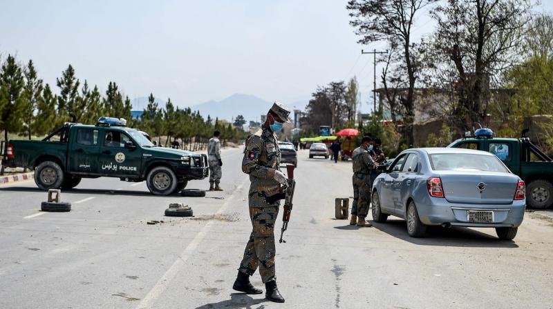 Security personnel wearing facemasks stop motorists at a checkpoint during a government-imposed lockdown as a preventive measure against the COVID-19 coronavirus in Kabul. (AFP)