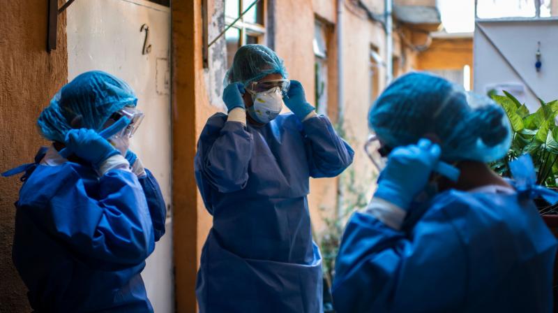 A health brigade gets ready while on door-to-door visits to carry out COVID-19 tests in Mexico City. (AFP) A health brigade gets ready while on door-to-door visits to carry out COVID-19 tests in Mexico City. (AFP)