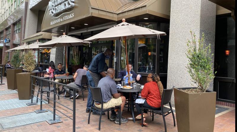 People eat at a restaurant in Washington, DC. (AFP)