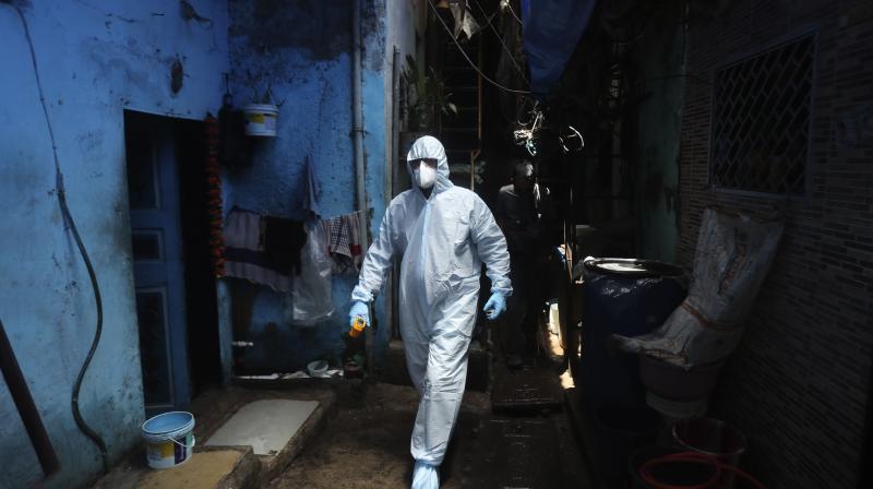 A doctor walks in a lane during a free medical camp in Dharavi, one of Asias largest slums in Mumbai, India. (AP)