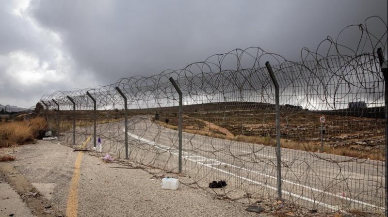 A section of Israel's separation barrier blocks a road near the West Bank Jewish settlement of Beit Horon. (AP) A section of Israel's separation barrier blocks a road near the West Bank Jewish settlement of Beit Horon. (AP)