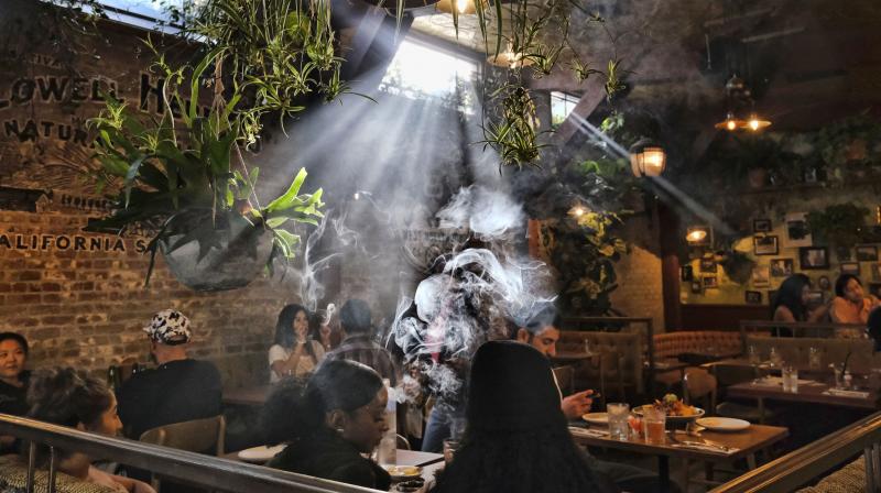 Patrons smoke marijuana at Lowells Original Cannabis Cafe, a legal marijuana establishment, in Los Angeles. (AP)