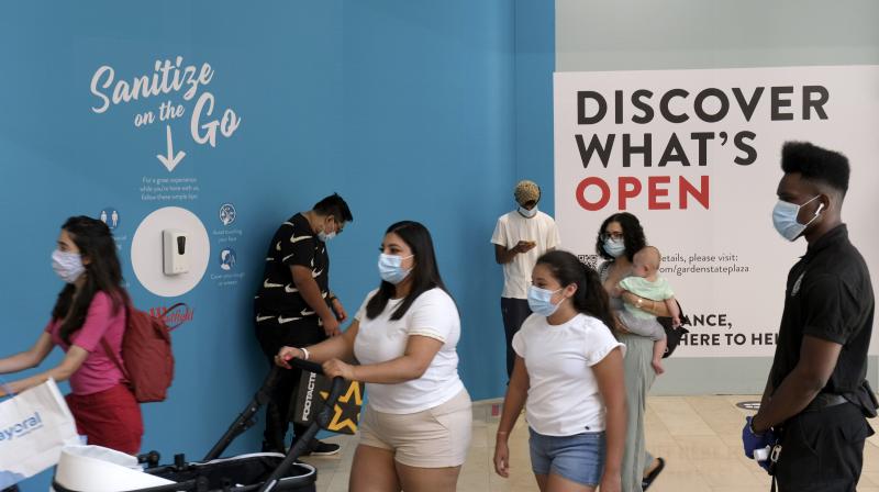 Shoppers walk around Garden State Plaza in Paramus, N.J., as New Jerseys indoor shopping malls reopened Monday from their COVID-19 pause.(AP)