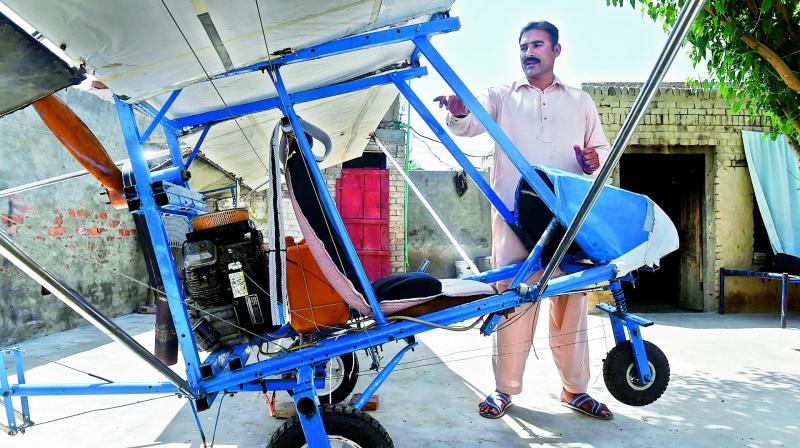Pakistani villager Muhammad Fayyaz stands alongside his small plane at his residence in Tabur village in central Punjab province. It has caught the imagination of the Air Force which apparently gave him a certificate commending his work. — AFP Pakistani villager Muhammad Fayyaz stands alongside his small plane at his residence in Tabur village in central Punjab province. It has caught the imagination of the Air Force which apparently gave him a certificate commending his work. — AFP