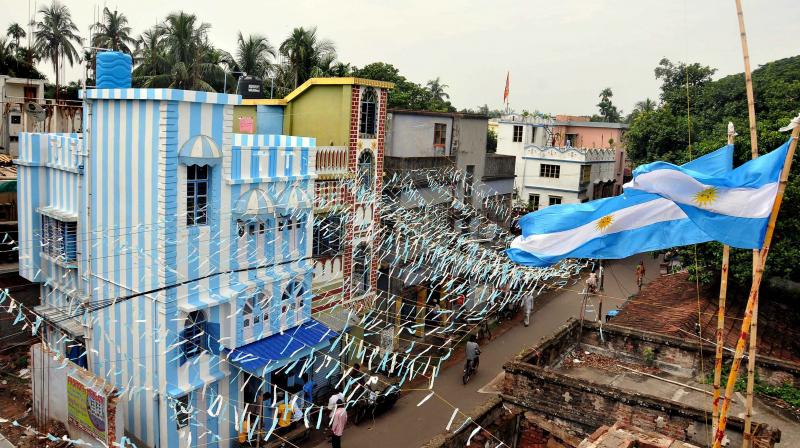 But when a Kolkata-based travel agent informed him that his savings — a princely amount of ₹60,000 — are not enough to fund his World Cup trip, he decided the next best thing — paint his entire three-storey building in Argentina colours. (Photo: PTI) But when a Kolkata-based travel agent informed him that his savings — a princely amount of ₹60,000 — are not enough to fund his World Cup trip, he decided the next best thing — paint his entire three-storey building in Argentina colours. (Photo: PTI)