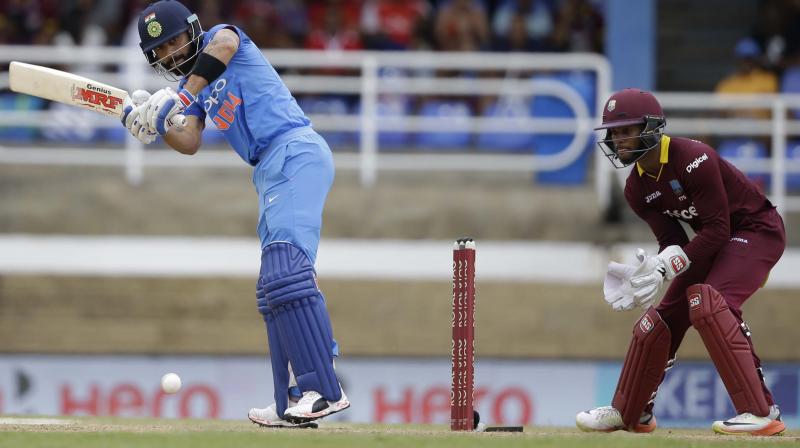 India's captain Virat Kohli plays a shot under the watch of West Indies' Shai Hope during their second ODI cricket match at Queen's Park Oval in Port of Spain. (Photo: AP) India's captain Virat Kohli plays a shot under the watch of West Indies' Shai Hope during their second ODI cricket match at Queen's Park Oval in Port of Spain. (Photo: AP)