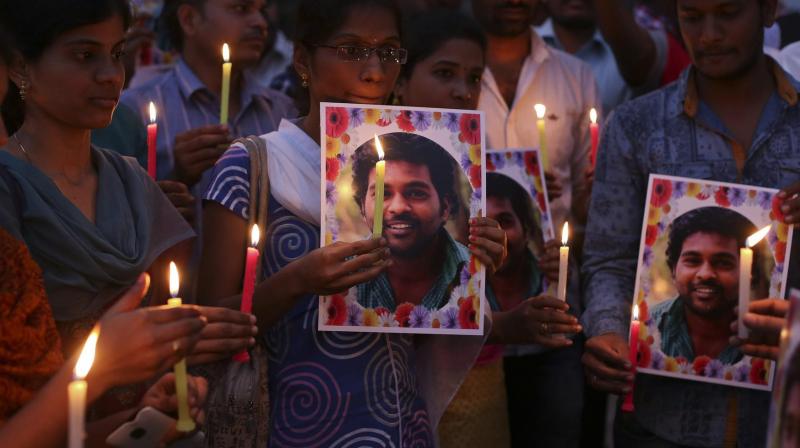 Activist of a Dalit organization participate in a candle light vigil holding photographs of Indian student Rohith Vemula in Hyderabad. (Photo: AP) Activist of a Dalit organization participate in a candle light vigil holding photographs of Indian student Rohith Vemula in Hyderabad. (Photo: AP)