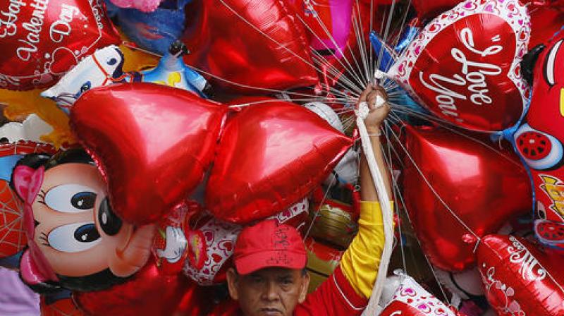 A vendor sells balloons on Valentine's Day. (Photo: AP) A vendor sells balloons on Valentine's Day. (Photo: AP)