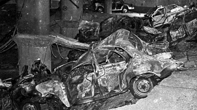 People carry a victim from the Air India building after the serial blasts in Mumbai in 1993. (Photo: PTI/File) People carry a victim from the Air India building after the serial blasts in Mumbai in 1993. (Photo: PTI/File)
