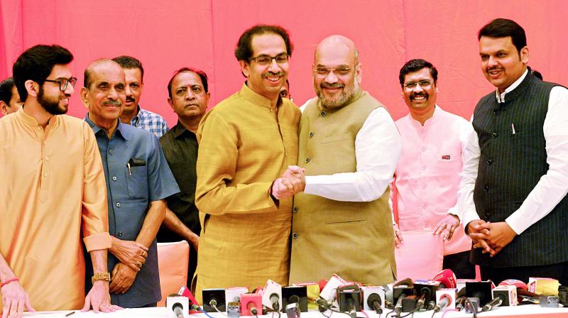 Shiv Sena President Uddhav with BJP President Amit Shah at press conference in Mumbai, Monday. (DC) Shiv Sena President Uddhav with BJP President Amit Shah at press conference in Mumbai, Monday. (DC)