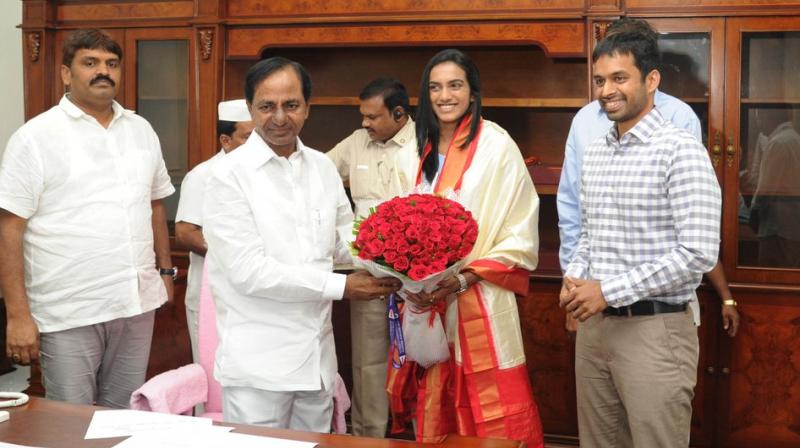 Back in India after winning a silver medal at the World Badminton Championships in Glasgow, PV Sindhu, alongside coach Pullela Gopichand, met Telangana Chief Minister K Chandrasekhar Rao. (Photo: Telangana CMO Twitter) Back in India after winning a silver medal at the World Badminton Championships in Glasgow, PV Sindhu, alongside coach Pullela Gopichand, met Telangana Chief Minister K Chandrasekhar Rao. (Photo: Telangana CMO Twitter)