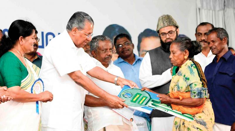 Chief Minister Pinarayi Vijayan hands over the key of a 2 BHK flat to a beneficiary at the inauguration of the apartment complex 'Pratheeksha'at Muttathara in Thiruvananthapuram on Wednesday. Chief Minister Pinarayi Vijayan hands over the key of a 2 BHK flat to a beneficiary at the inauguration of the apartment complex 'Pratheeksha'at Muttathara in Thiruvananthapuram on Wednesday.