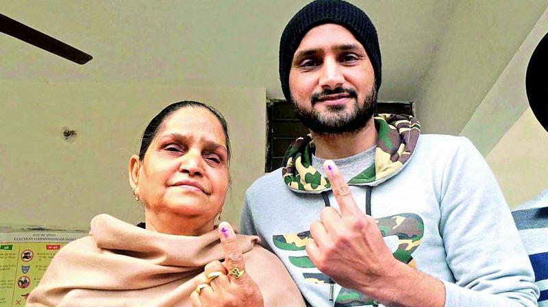 Cricketer Harbhajan Singh and his mother show indelible ink marked on their fingers after casting their votes at a polling station in Jalandhar, Punjab on Saturday. (Photo: PTI) Cricketer Harbhajan Singh and his mother show indelible ink marked on their fingers after casting their votes at a polling station in Jalandhar, Punjab on Saturday. (Photo: PTI)