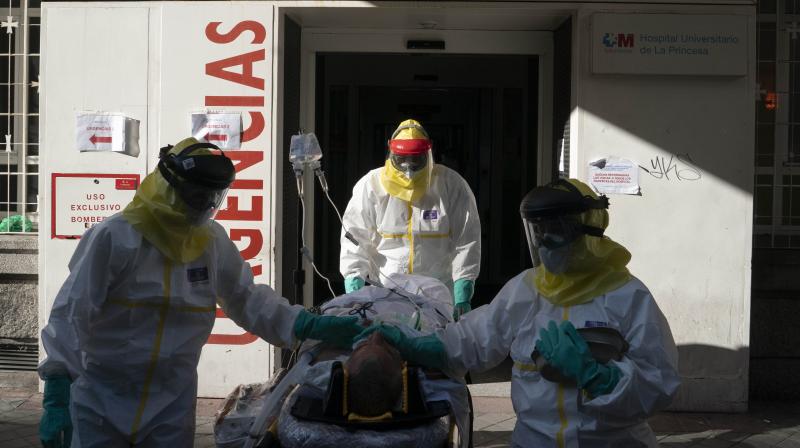 In this handout picture made available on April 9, 2020 by the Comunidad de Madrid (Madrid regional government) doctors attend a COVID-19 disease patient transferred by members of the Comunidad de Madrids Biological Risk Medical Emergency Service in Madrid. AFP Photo