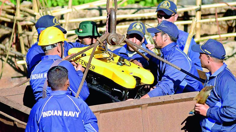 Navy personnel conduct rescue task at the site of the coal mine collapse at Ksan, in Jaintia Hills district of Meghalaya, Monday. (Photo: AP) Navy personnel conduct rescue task at the site of the coal mine collapse at Ksan, in Jaintia Hills district of Meghalaya, Monday. (Photo: AP)