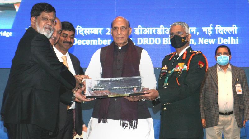 Minister for Defence Rajnath Singh hands over the Defence Research & Development Organisation developed products to Armed Forces and other security agencies, at an event in New Delhi, Tuesday, December 14, 2021. (PTI)