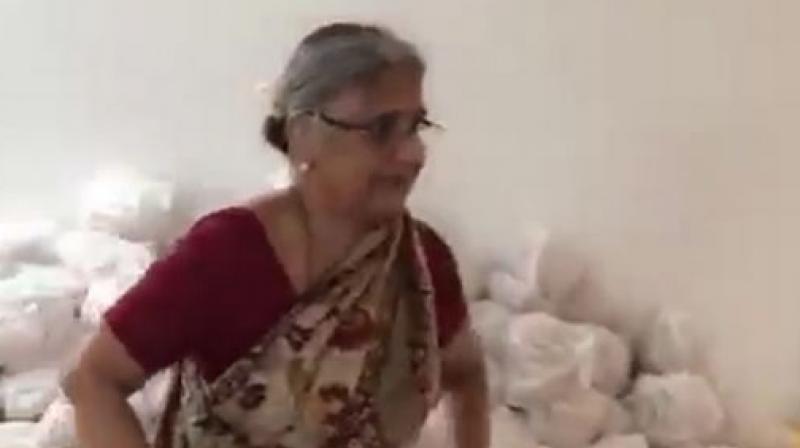 Infosys co-founder NR Narayana Murthy's wife Sudha Murthy is seen supervising the relief material packed in bags embossed with Infosys. (Photo: Twitter Screengrab | @DVSBJP) Infosys co-founder NR Narayana Murthy's wife Sudha Murthy is seen supervising the relief material packed in bags embossed with Infosys. (Photo: Twitter Screengrab | @DVSBJP)