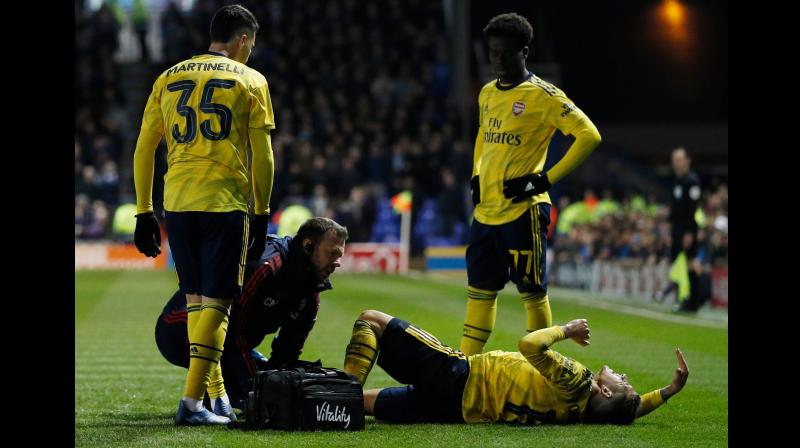 Arsenals Uruguayan midfielder Lucas Torreira gets attention for an injury during the English FA Cup fifth round match against Portsmouth at Fratton Park stadium in Portsmouth, southern England, on March 2. AFP Photo