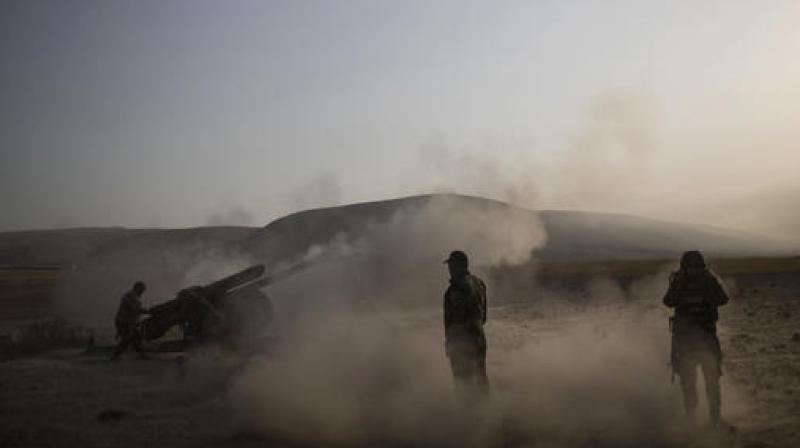 Kurdish Peshmerga soldiers fire artillery at Islamic State positions in Bashiqa, east of Mosul. (Photo: AP) Kurdish Peshmerga soldiers fire artillery at Islamic State positions in Bashiqa, east of Mosul. (Photo: AP)
