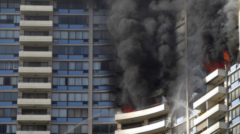 Smoke billows from the upper floors of the Marco Polo apartment complex in Honolulu (Photo: AP) Smoke billows from the upper floors of the Marco Polo apartment complex in Honolulu (Photo: AP)