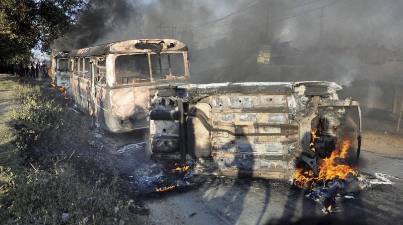 Angry people set on fire vehicles in Imphal East district on Sunday in protest against the United Naga Council (UNC)'s indefinite economic blockade. (Photo: PTI) Angry people set on fire vehicles in Imphal East district on Sunday in protest against the United Naga Council (UNC)'s indefinite economic blockade. (Photo: PTI)