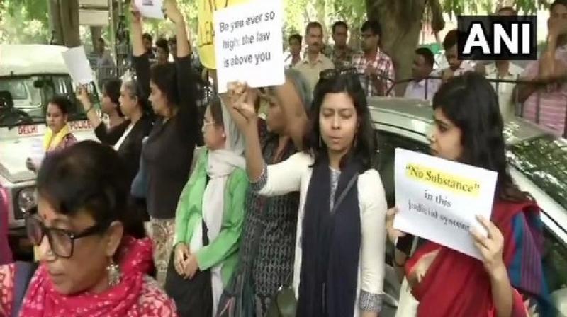 Fifty-five protesters, mostly women lawyers and activists, were detained outside the Supreme Court here while they were agitating against the procedure adopted to deal with a sexual harassment case against Chief Justice of India Ranjan Gogoi. (Photo: ANI) Fifty-five protesters, mostly women lawyers and activists, were detained outside the Supreme Court here while they were agitating against the procedure adopted to deal with a sexual harassment case against Chief Justice of India Ranjan Gogoi. (Photo: ANI)