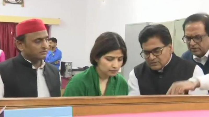 Dimple Yadav along with Akhilesh Yadav took part in a road show atop a rath (chariot) from Faguha Bhutta in the presence of large number of SP and BSP workers and leaders who chanted slogans. (Image: ANI) Dimple Yadav along with Akhilesh Yadav took part in a road show atop a rath (chariot) from Faguha Bhutta in the presence of large number of SP and BSP workers and leaders who chanted slogans. (Image: ANI)