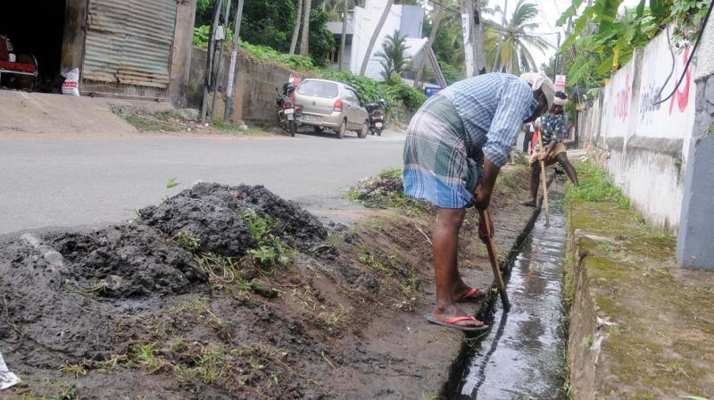 Desilting works in progress at a drain in the city, with the silt and filth kept beside the drain. (Photo: A.V. MUZAFAR) Desilting works in progress at a drain in the city, with the silt and filth kept beside the drain. (Photo: A.V. MUZAFAR)