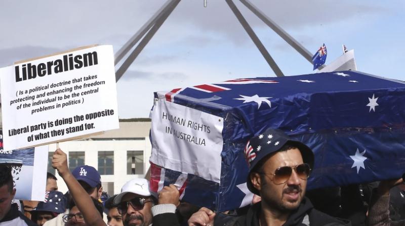 Protestors hold up a placard and a symbolic coffin during a refugee protest at Parliament House in Canberra, Australia, Monday, July 29, 2019. (Photo: AP) Protestors hold up a placard and a symbolic coffin during a refugee protest at Parliament House in Canberra, Australia, Monday, July 29, 2019. (Photo: AP)