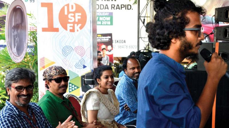 Ajayan Adat, sound designer, speaks at the impromptu protest meeting at the ISDFFK in Thiruvananthapuram on Sunday. Director Amudan, Bengali director Supriyo Sen, Priya Thoovassery, and K.M. Kamal looks on. (Photo: DC) Ajayan Adat, sound designer, speaks at the impromptu protest meeting at the ISDFFK in Thiruvananthapuram on Sunday. Director Amudan, Bengali director Supriyo Sen, Priya Thoovassery, and K.M. Kamal looks on. (Photo: DC)