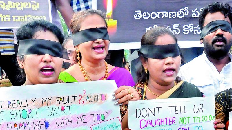 NGO members stage a protest with a cloth tied to their eyes against sexual assualts at the People’s Plaza on Sunday. (Photo: P. Surendra) NGO members stage a protest with a cloth tied to their eyes against sexual assualts at the People’s Plaza on Sunday. (Photo: P. Surendra)