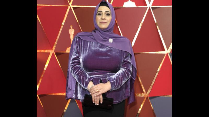 Syrian refugee Hala Kamil, the subject of the Oscar-nominated short documentary “Watani: My Homeland” attended the Academy awards in a purple and black two-piece velvet gown with a matching purple hijab by Lady Gaga’s stylist Brandon Maxwell. (Photo: AP) Syrian refugee Hala Kamil, the subject of the Oscar-nominated short documentary “Watani: My Homeland” attended the Academy awards in a purple and black two-piece velvet gown with a matching purple hijab by Lady Gaga’s stylist Brandon Maxwell. (Photo: AP)