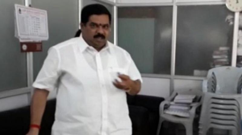The video posted by local channels show Narayanaswamy splashing petrol from a bottle in the BBMP office at Bengaluru's Horamavu. (Photo: Screengrab) The video posted by local channels show Narayanaswamy splashing petrol from a bottle in the BBMP office at Bengaluru's Horamavu. (Photo: Screengrab)