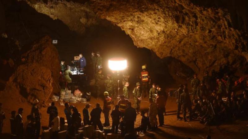 A video shot by rescuers in flickering torchlight revealed boys clad in shorts and red and blue shirts sitting or standing on the rock above an expanse of water. (Photo: AFP) A video shot by rescuers in flickering torchlight revealed boys clad in shorts and red and blue shirts sitting or standing on the rock above an expanse of water. (Photo: AFP)