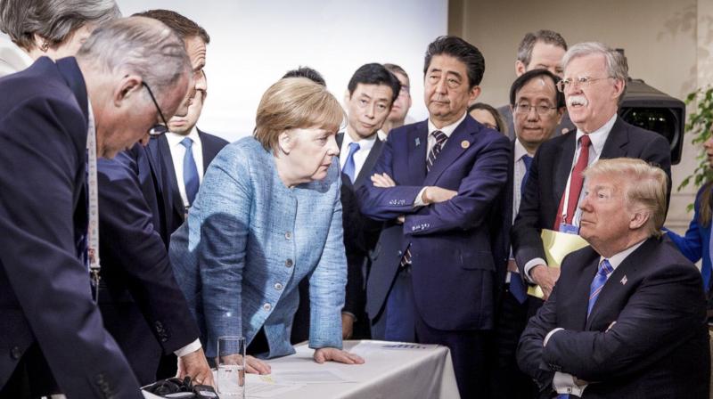 Her fists planted on the table, she looms above an apparently nervous Trump, looking up at her and listening without response. (Photo: AP) Her fists planted on the table, she looms above an apparently nervous Trump, looking up at her and listening without response. (Photo: AP)