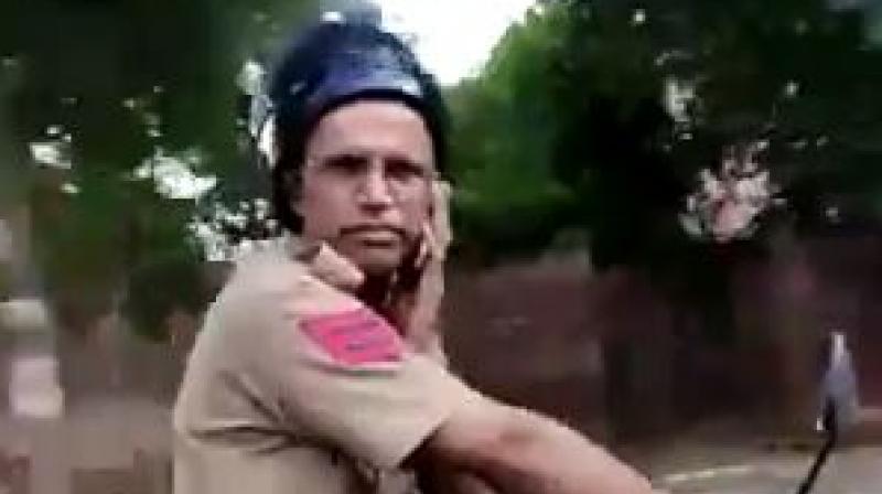 A video of head constable Surinder Singh slapping the local went viral on social media. He wasn't even wearing his helmet properly. (Photo: screengrab) A video of head constable Surinder Singh slapping the local went viral on social media. He wasn't even wearing his helmet properly. (Photo: screengrab)