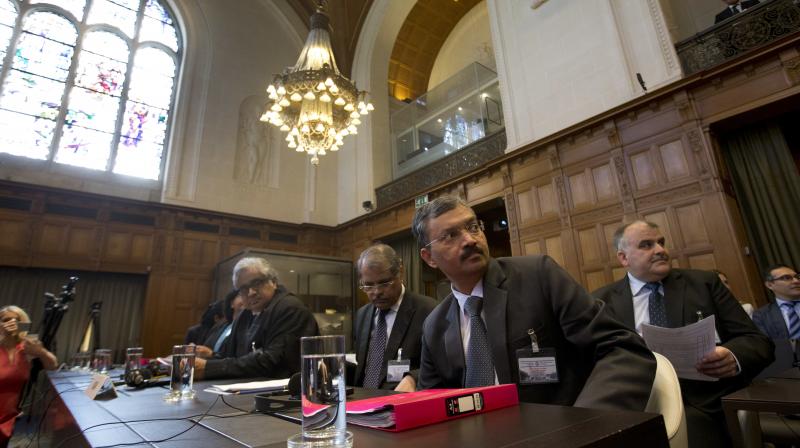 Dr Deepak Mittal, joint secretary of India's Ministry of External Affairs, front row right, and his delegation wait for judges to enter the World Court in The Hague, Netherlands, Monday. (Photo: PTI) Dr Deepak Mittal, joint secretary of India's Ministry of External Affairs, front row right, and his delegation wait for judges to enter the World Court in The Hague, Netherlands, Monday. (Photo: PTI)