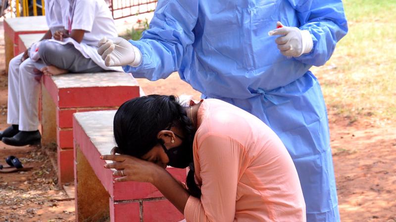 A girl reacts while she undergoes a swab test by medical staff for COVID testing at Urban Primary Health Centre at Chinnawaltair in Visakhapatnam. (Representational DC Image)