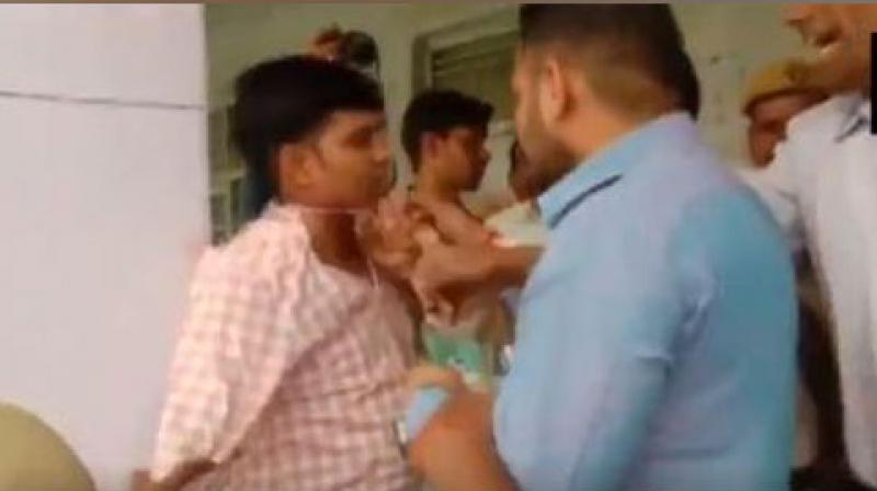 Bharatiya Janata Party (BJP) workers on Tuesday allegedly beat up an Election Official at booth number 231 in Moradabad Lok Sabha constituency. (Photo: screengrab) Bharatiya Janata Party (BJP) workers on Tuesday allegedly beat up an Election Official at booth number 231 in Moradabad Lok Sabha constituency. (Photo: screengrab)