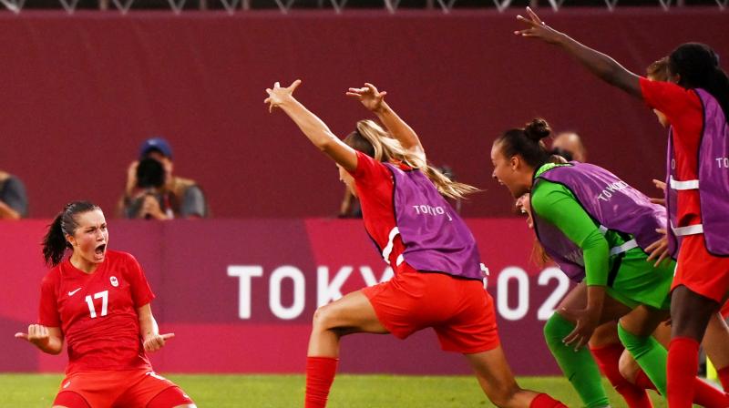 Canadas midfielder Jessie Fleming (left) celebrates with teammates after scoring the opening goal during the Tokyo 2020 Olympic Games womens semi-final football match between the United States and Canada at Ibaraki Kashima Stadium in Kashima on Monday. (Photo: AFP)