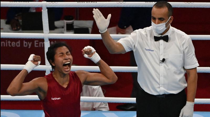 Indias Lovlina Borgohain (red) celebrates after winning against Chinese Taipeis Nien-Chin Chen after their womens welter (64-69kg) quarter-final boxing match during the Tokyo Olympic Games at the Kokugikan Arena in Tokyo on July 30. (Photo: AFP)