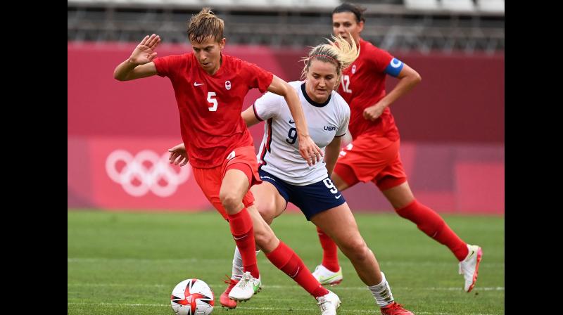 Canadas midfielder Quinn (L) is marked by USAs midfielder Lindsey Horan (R) during the Tokyo 2020 Olympic Games womens semi-final football match between the United States and Canada at Ibaraki Kashima Stadium in Kashima on Tuesday. (Photo: AFP)