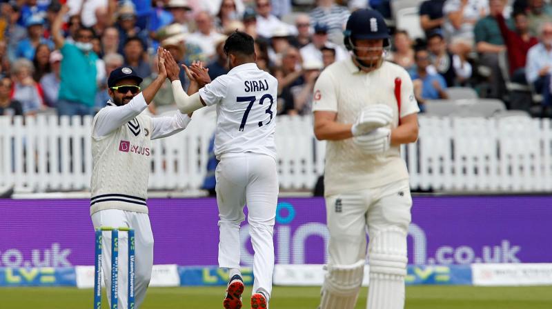 Indias Mohammed Siraj (C) celebrates taking the wicket of Englands Jonny Bairstow (R) for 57 runs on the third day of the second cricket Test match between England and India at Lords cricket ground in London on Saturday. (Photo: AFP)