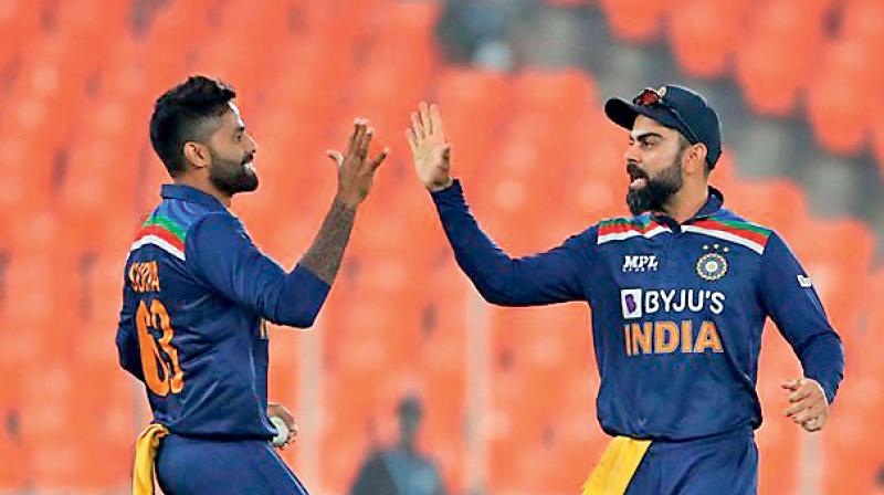 Suryakumar Yadav celebrates with India captain Virat Kohli in this file photo. (Photo by Surjeet_Yadav/Getty Images)