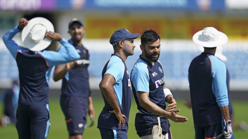 Indias Virat Kohli, second right, gestures as he speaks during a nets session at Headingley cricket ground in Leeds, England, Monday, Aug. 23, 2021, ahead of the 3rd Test cricket match between England and India. (AP Photo)