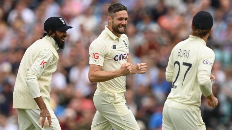 Englands Chris Woakes celebrates after taking the wicket of Indias Rohit Sharma during play on the first day of the fourth cricket Test match between England and India at the Oval cricket ground in London on Thursday. (Photo: AFP)