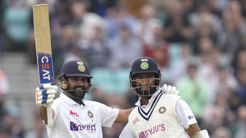 India's Rohit Sharma, left, celebrates scoring 100 runs with batting partner India's Cheteshwar Pujara on day three of the fourth Test match at The Oval cricket ground in London on Saturday. (Photo: AP) India's Rohit Sharma, left, celebrates scoring 100 runs with batting partner India's Cheteshwar Pujara on day three of the fourth Test match at The Oval cricket ground in London on Saturday. (Photo: AP)