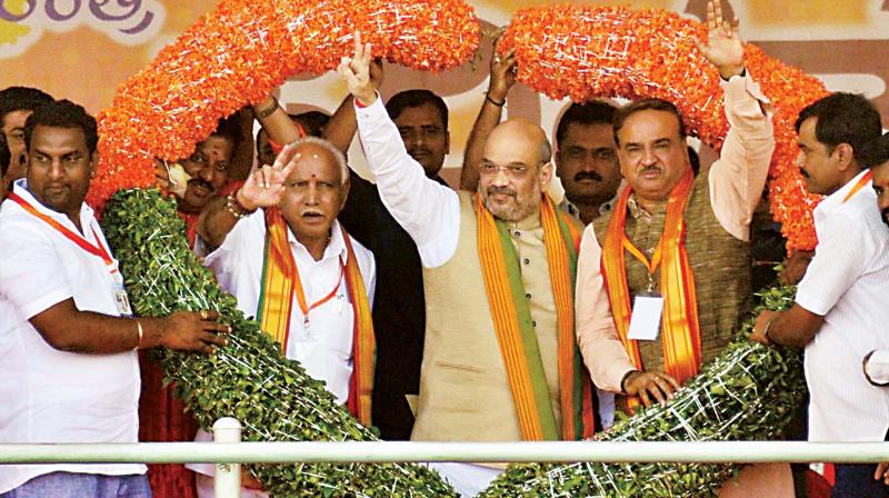 State BJP chief B.S. Yeddyurappa, party president Amit Shah and union minister H.N. Ananth Kumar at the launch of Nava Nirmana Parivarthana Yatra in Bengaluru on Thursday. (Photo: KPN) State BJP chief B.S. Yeddyurappa, party president Amit Shah and union minister H.N. Ananth Kumar at the launch of Nava Nirmana Parivarthana Yatra in Bengaluru on Thursday. (Photo: KPN)